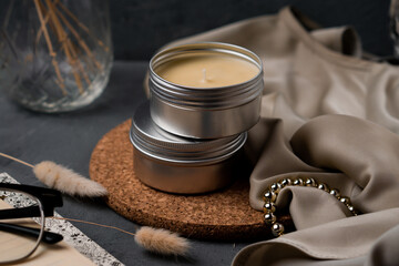 Soy candles in metal cans, handmade modern hobby , soy wax candles on cozy background.Massage...