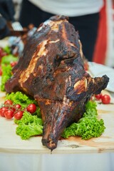 Baked piglet on the festive table. Meat dishes at the restaurant.