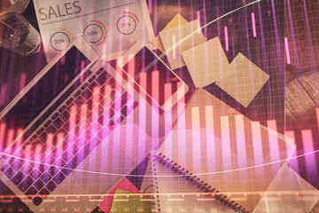 Financial market graph and top view computer on the desktop background. Multi exposure. Investment concept.