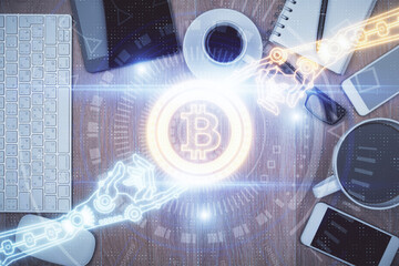 Double exposure of blockchain theme hologram over table with phone. Top view. Crypto technology...