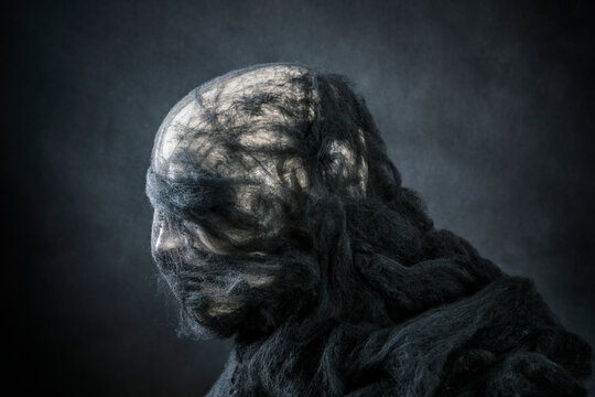 Creepy figure on dark misty background