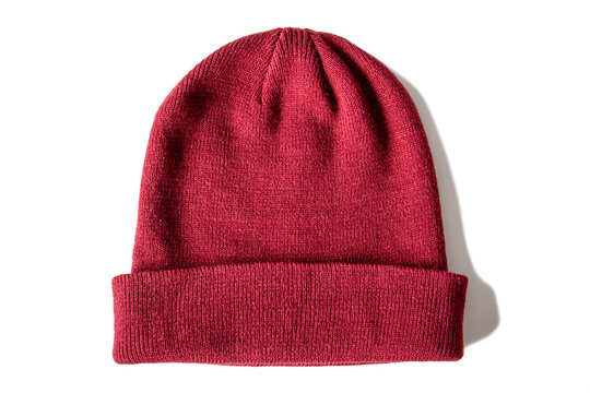 Warm knitted red wool hat on insulated white background, top view