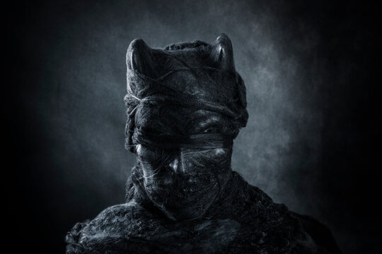Portrait of a horned demon on dark misty background