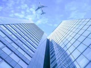 Fototapeta na wymiar Airplane flying over buildings in Vienna