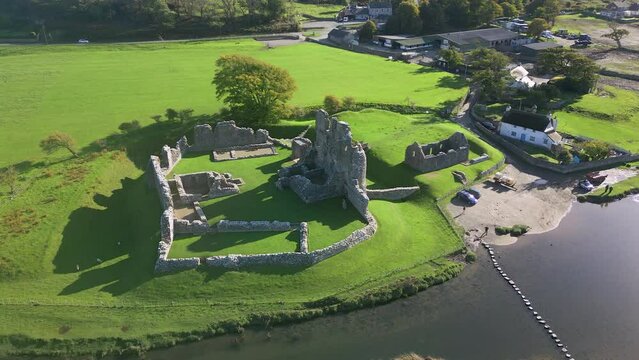 Aerial view orbiting the ruins of Ogmore Castle, Wales