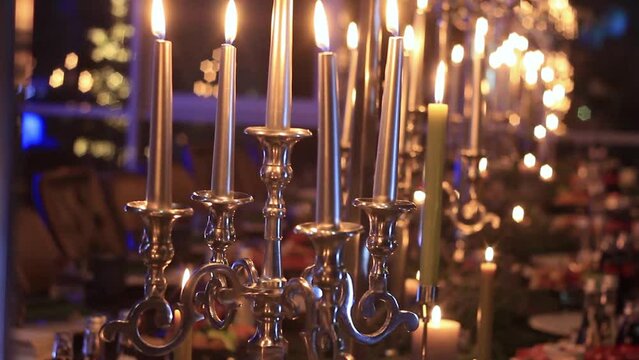 Dim light of candles burning and illuminating restaurant
