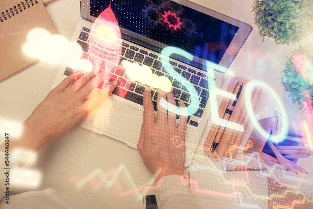 Poster double exposure of woman hands working on computer and seo hologram drawing. top view. search optimi