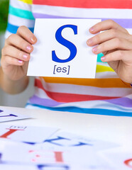 The child learns English letters. Selective focus.