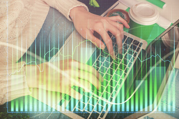 Double exposure of woman hands typing on computer and forex chart hologram drawing. Stock market invest concept.