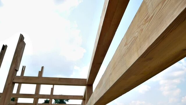 construction of new housing from environmentally friendly materials
the initial stage of construction. assembling the frame of the building made of wooden beams. motion steadicam. beautiful deep blue 