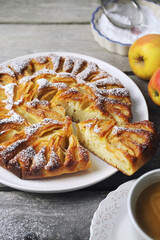Apple pie and cup of coffee, powdered sugar dressing