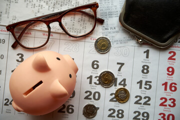paragony fiskalne , polskie monety, kartka z kalendarza, świnka skarbonka, emerytura