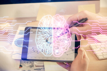 Double exposure of man's hand holding and using a digital device and brain hologram drawing. Data concept.