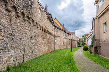 A medieval wall and walking path inside the Bavarian fortified town of Mockmuhl, Germany. - obrazy, fototapety, plakaty