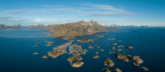 Incredible aerial view of Henningsvaer, football field and mountains in the background.