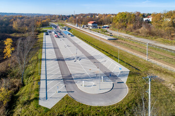 P+R - Park and Ride big parking lot, with facilities for disabled and a small railway station in Swoszowice district in Krakow, Poland, for fast city train to the town center and regional transport - obrazy, fototapety, plakaty