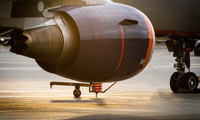 Jet engine under the wing of a modern passenger aircraft at an international airport
