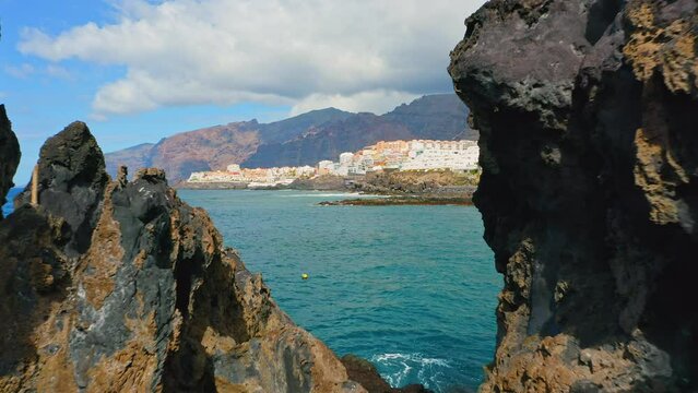 Tenerife, Canary Island Charco El Diablo. Natural pool of Devil. View of black lava flows, volcanic bizzare stones, rocky volcanic beach, Atlantic Ocean. Cueva la Vaca.