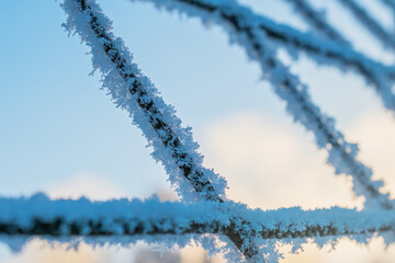Soccer goal net covered with ice and snow close up. Winter mood background