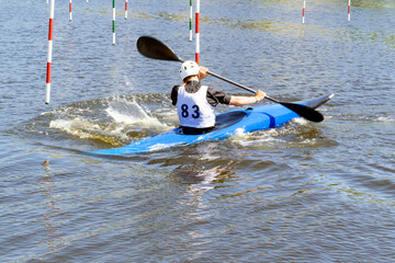 Athlete on a kayak during a rowing slalom competition.