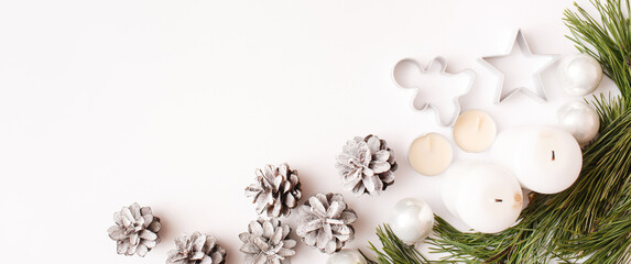 Christmas Banner. winter, new year composition. Fir tree branches, pine cone, candles on white background. Flat lay, top view, copy space