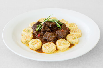 Hungarian beef goulash with chive dumplings - obrazy, fototapety, plakaty