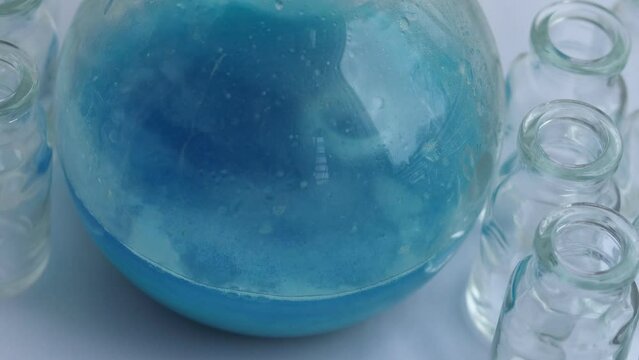 Chemical reaction of neutralization of an acidic solution of copper nitrate with sodium bicarbonate. Carbon dioxide and copper hydroxycarbonate precipitate are formed.