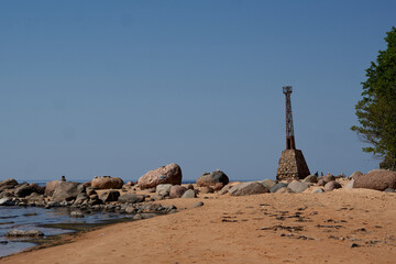 Old ruins of lighthouse on the shore of Baltic beach, in Kurmrags, Latvia - obrazy, fototapety, plakaty
