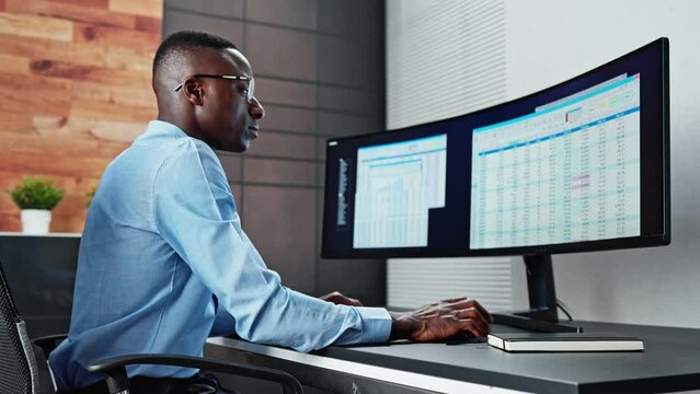 Data Analyst African Man Using Spreadsheet