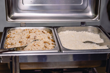 stainless steel buffet on the table with Greek rice
