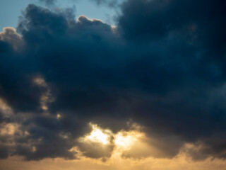 Scary sunset sky with light in a shape of eyes glowing.