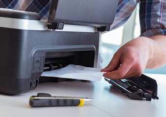 Repairman repairing broken color printer