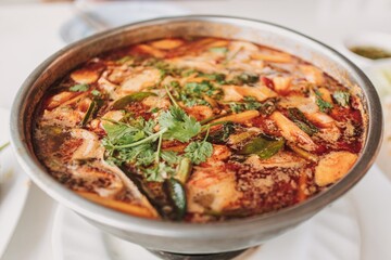 Tom Yam Ta Lay or Tom Yam Seafood. Popular hot and spicy Thai food on the beach.