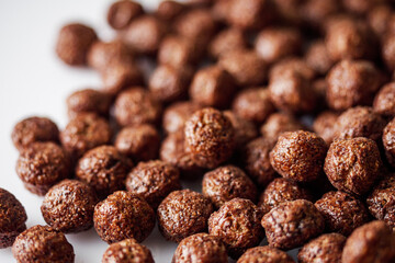 sweet crunchy chocolate children's breakfast chocolate balls on a white background