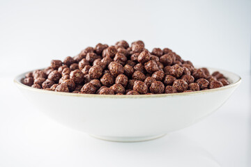 sweet crunchy chocolate children's breakfast chocolate balls on a white background