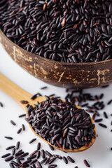 raw fresh black rice on a white background