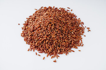 raw fresh red rice on a white background