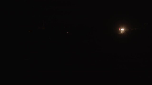Lorry moving on remote road in total darkness of the night