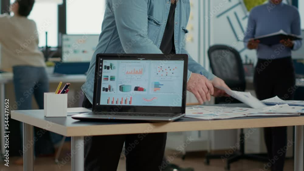 Poster closeup of laptop screen with enterprise resource planning showing moving charts and growing turnove