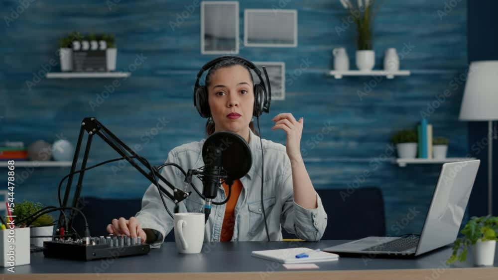 Poster attractive digital content creator checking microphone while recording daily vlog. video talk show h