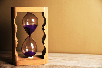 Hourglass on a wooden table