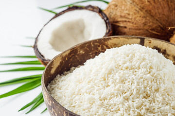 fresh natural coconut and shavings dried flakes on white acrylic background