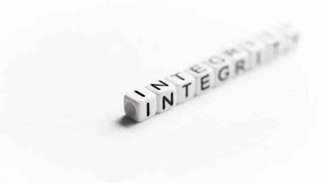 Word Integrity on white background. This term means the quality of being honest and having strong moral principles. It describes personal moral uprightness.