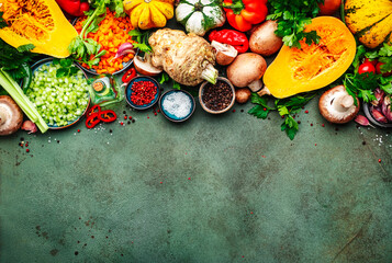 Autumn food. Vegetables, mushrooms, roots, spices, pumpkin - ingredients for vegan, vegetarian cooking.  Thanksgiving dinner preparation. Healthy eating, slow food. Rustic table background, top view