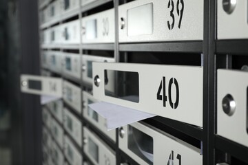 Open mailboxes with keyholes, numbers and receipts, closeup