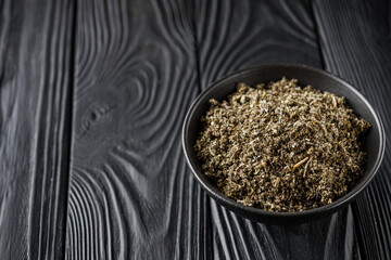 aromatic green dried sage on a black wooden rustic background