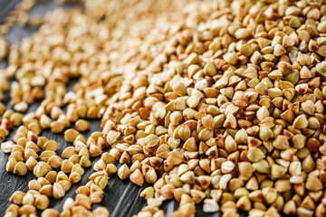 organic raw green buckwheat on a black background