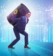 Businessman under the burden of oil barrel