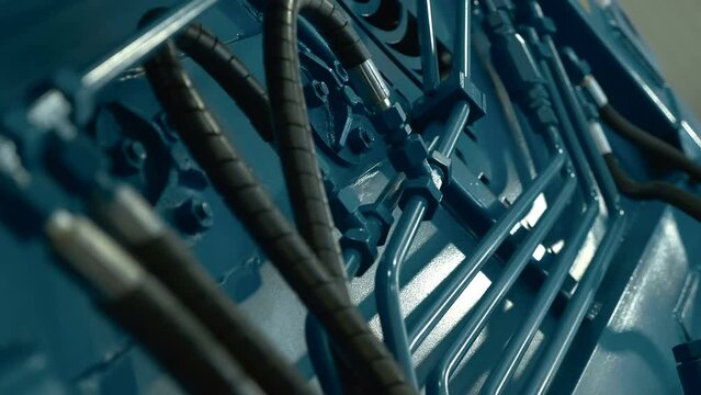 Block of connecting hydraulic rubber hoses to metal pipes of the main hydraulic line of a new truck. Shot in motion. Closeup