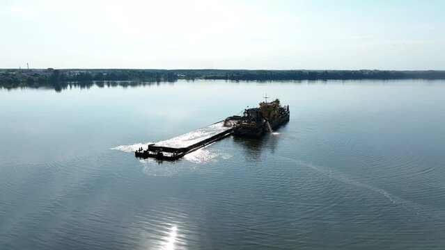 Aerial view. A dredger for extracting river sand and cleaning the river bottom in the middle of the Volga.